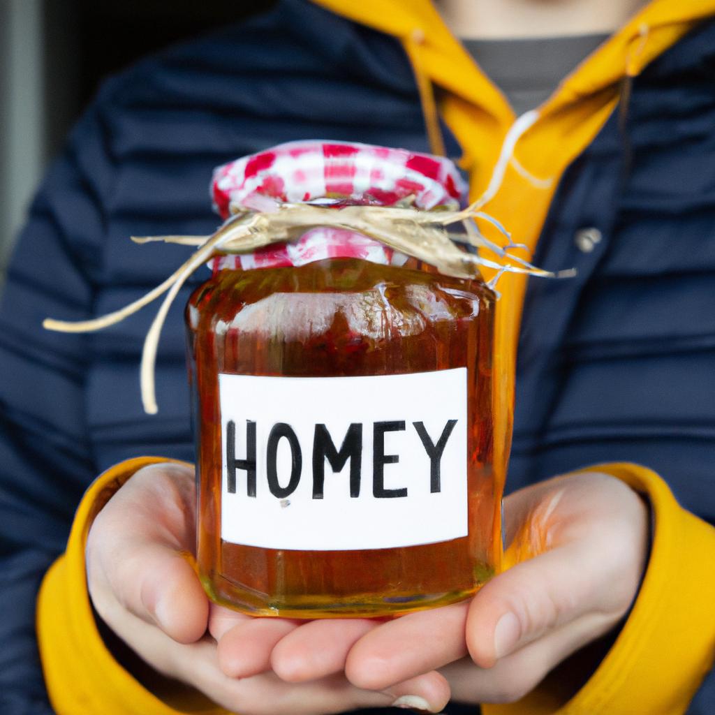 Person holding a jar of honey freshly harvested from one hive